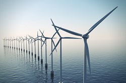 Row of floating wind turbines during hazy day.